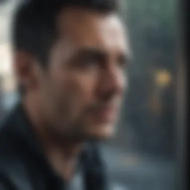 A man looking out of a rain-soaked window with a pensive expression