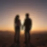 Silhouette of a couple standing together facing the sunset