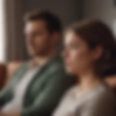 A couple sitting apart on a couch, showcasing emotional distance