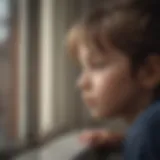 A child gazing out of a window, reflecting feelings of isolation and longing.